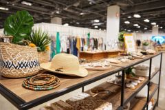 Focused medium shot of a temporary popup setup showcasing trendy accessories with the foreground in sharp detail and store environment softly blurred.